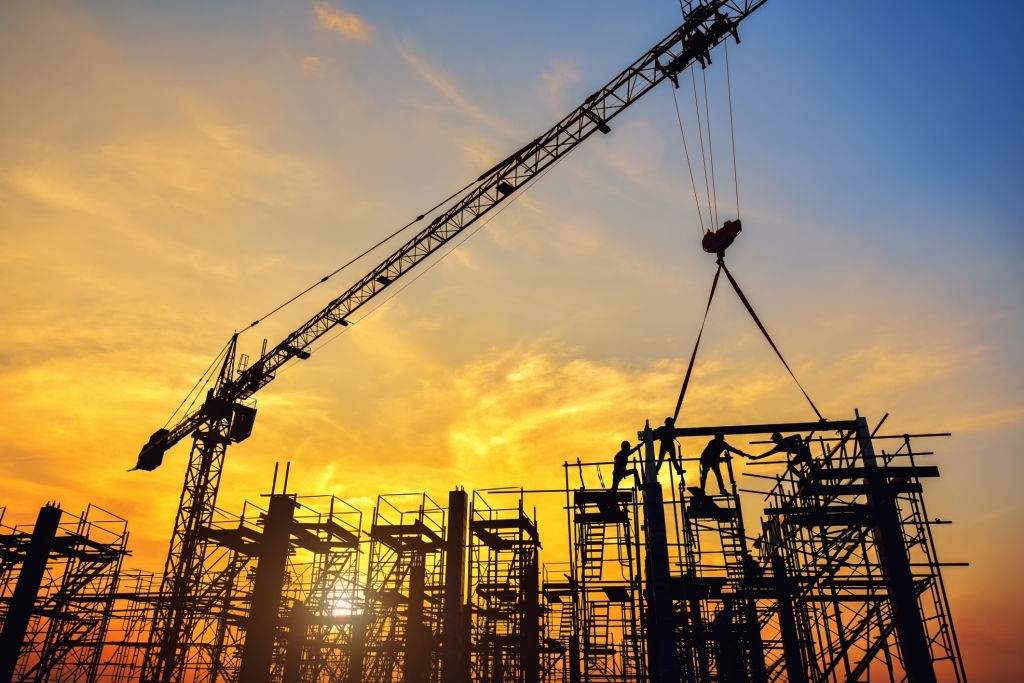 Silhouette of engineer and safety officer looking construction worker